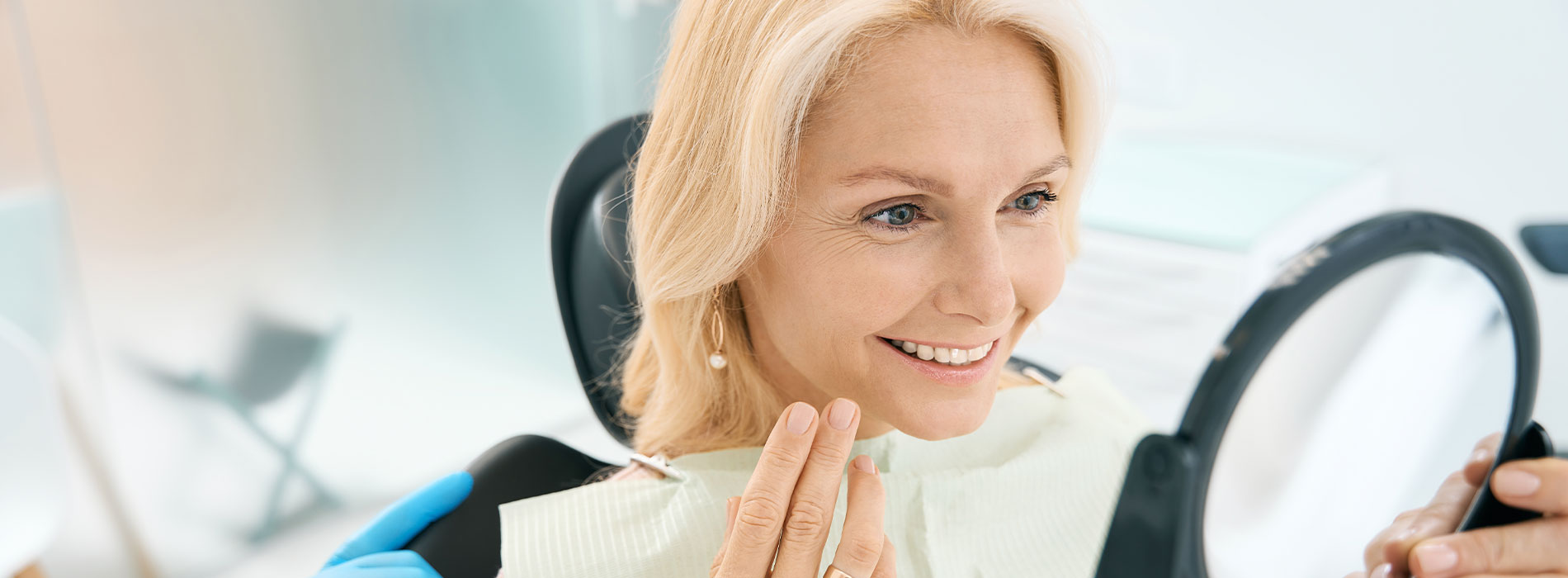 The image shows a modern dental clinic interior with various pieces of equipment, including a dental chair and an X-ray machine.